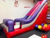 COMMERCIAL INFLATABLE 18 FT SLIDE WITH BLOWER AND ROUND MULTI-LEVEL CLIMBING PLAY STRUCTURE. INCLUDES INFLATABLE SLIDE, BLOWER FAN, METAL FRAME PLAY TOWER, NETTING, AND PADDED SUPPORTS. DISASSEMBLY REQUIRED. - 2