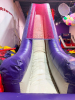 COMMERCIAL INFLATABLE 18 FT SLIDE WITH BLOWER AND ROUND MULTI-LEVEL CLIMBING PLAY STRUCTURE. INCLUDES INFLATABLE SLIDE, BLOWER FAN, METAL FRAME PLAY TOWER, NETTING, AND PADDED SUPPORTS. DISASSEMBLY REQUIRED. - 4