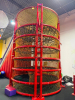 COMMERCIAL INFLATABLE 18 FT SLIDE WITH BLOWER AND ROUND MULTI-LEVEL CLIMBING PLAY STRUCTURE. INCLUDES INFLATABLE SLIDE, BLOWER FAN, METAL FRAME PLAY TOWER, NETTING, AND PADDED SUPPORTS. DISASSEMBLY REQUIRED. - 10
