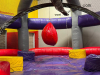 LARGE COMMERCIAL &ldquo;WRECKING BALL&rdquo; INTERACTIVE INFLATABLE GAME BY INFLATABLE 2000 / BOUNCE U. PLAYERS STAND ON PEDESTALS WHILE SWINGING THE CENTER WRECKING BALL TO KNOCK OPPONENTS OFF BALANCE. - 3