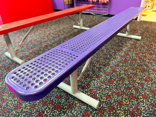8 FT PURPLE POWDER-COATED EXPANDED METAL BENCH WITH TUBULAR STEEL FRAME AND FLOOR-MOUNT STYLE SUPPORT LEGS.