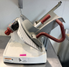 BERKEL MANUAL GRAVITY FEED MEAT SLICER WITH BUILT-IN SHARPENER, ADJUSTABLE SLICE THICKNESS CONTROL, AND ALUMINUM BODY CONSTRUCTION.