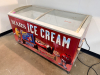EXCELLENCE COMMERCIAL GLASS TOP CHEST FREEZER WITH SLIDING GLASS LIDS, GRAPHIC EXTERIOR PANELS, AND MOBILE CASTER BASE.