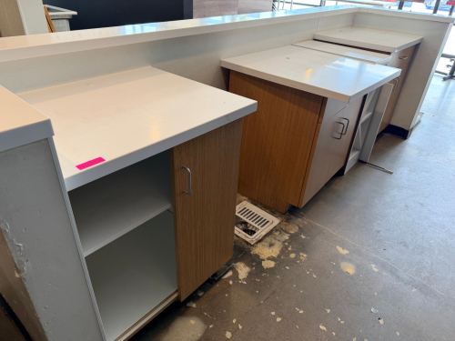 THREE PIECE LAMINATE CABINET AND COUNTER STATION SET WITH WHITE SOLID SURFACE COUNTERTOPS, STORAGE CABINETS, AND OPEN SHELVING.