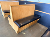 (2) SECTIONS OF 50" WOODEN BOOTH SEATING W/ BLACK PADDED SEAT CUSHIONS. - 2