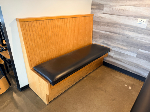 (2) SECTIONS OF 50" WOODEN BOOTH SEATING W/ BLACK PADDED SEAT CUSHIONS.