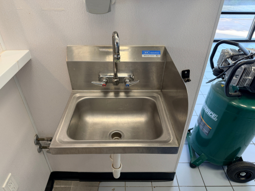 WALL MOUNTED STAINLESS HAND SINK.