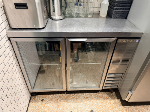 BEVERAGE-AIR BACK BAR REFRIGERATOR WITH TWO GLASS SWING DOORS, INTERNAL WIRE SHELVING, AND SELF-CONTAINED REFRIGERATION SYSTEM. UNIT FEATURES A STAINLESS STEEL TOP AND BLACK TRIM ACCENTS.