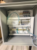 HOFFMAN ELECTRICAL CONTROL PANEL ENCLOSURE WITH PRE-WIRED TERMINAL BLOCKS, DIN RAIL COMPONENTS, STATUS INDICATOR LIGHTS, AND VIEWING WINDOW. STEEL NEMA-TYPE ENCLOSURE WITH LOCKING HANDLE. INTERIOR CONTAINS TERMINAL STRIPS, CIRCUIT PROTECTION COMPONENTS, A - 5