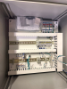 HOFFMAN ELECTRICAL CONTROL PANEL ENCLOSURE WITH PRE-WIRED TERMINAL BLOCKS, DIN RAIL COMPONENTS, STATUS INDICATOR LIGHTS, AND VIEWING WINDOW. STEEL NEMA-TYPE ENCLOSURE WITH LOCKING HANDLE. INTERIOR CONTAINS TERMINAL STRIPS, CIRCUIT PROTECTION COMPONENTS, A - 5