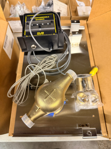 LMI / MILTON ROY MIKRO MASTER 300 REMOTE FLOWMETER-PULSER MOTOR KIT CONVERSION ASSEMBLY. INCLUDES PROGRAMMABLE DIVIDER CONTROL MODULE, BRASS FLOWMETER BODY, SENSOR CABLES, STAINLESS MOUNTING PANEL, AND HARDWARE. NEW IN BOX WITH MANUAL.
