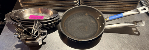 (2) 6" SKILLETS AND (1) STACK OF SMALL STAINLESS PASTA DISHES.