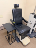 BURTON OPHTHALMIC EXAM CHAIR WITH PADDED VINYL UPHOLSTERY, ADJUSTABLE HEADREST, PADDED ARMRESTS, AND INTEGRATED FOOT PLATFORM. MANUAL RECLINING AND HEIGHT ADJUSTMENT FEATURES WITH METAL BASE CONSTRUCTION. - 2