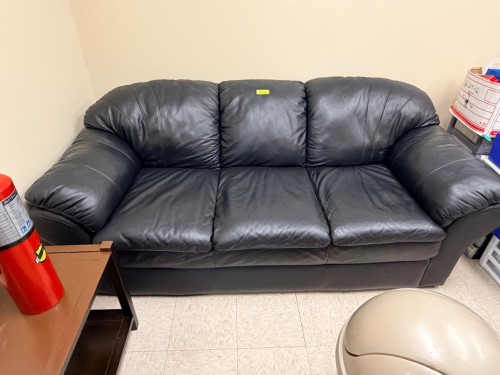 BLACK PLEATHER THREE CUSHION SOFA.