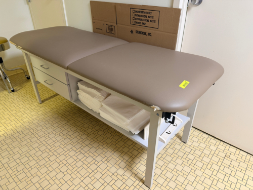 MEDICAL EXAMINATION / TREATMENT TABLE WITH STORAGE DRAWERS AND LOWER SHELF. PADDED TWO-SECTION VINYL TOP WITH METAL FRAME CONSTRUCTION
