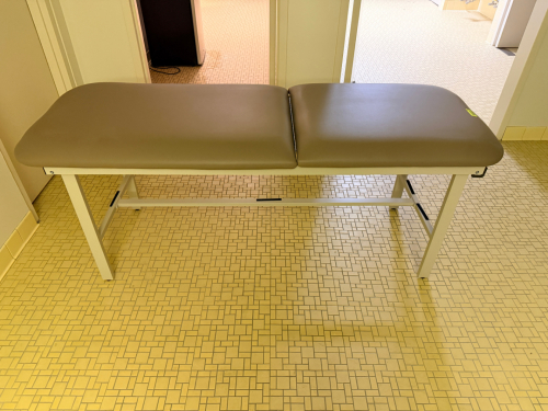PADDED MEDICAL / EXAMINATION TABLE WITH TWO-SECTION VINYL CUSHION TOP AND WHITE POWDER-COATED METAL FRAME