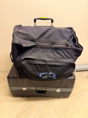 BLACK CANVAS ROAD BAG AND (1) HARD PLASTIC ROAD CASE.