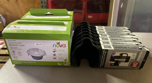 (2) BOXES OF COMMODE BUCKET LINER AND (1) LOT OF CUP HOLDERS
