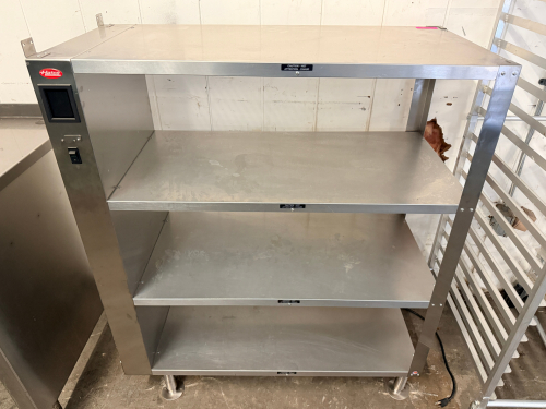 HATCO STAINLESS STEEL HEATED PASS-THROUGH SHELVING UNIT WITH FOUR-TIER OPEN SHELF DESIGN. HEAVY-DUTY STAINLESS STEEL CONSTRUCTION WITH INTEGRATED HEATING SYSTEM
