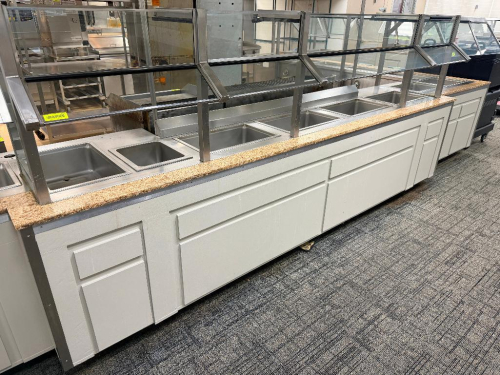 126" STAINLESS STEEL SERVING LINE WITH GLASS SNEEZE GUARDS, (5) WELLS MODEL 1DD100D HEATED DROP-IN FOOD WELLS,. STAINLESS STEEL BASE TABLES MAY BE INCLUDED AT THE WINNING BIDDER'S OPTION.