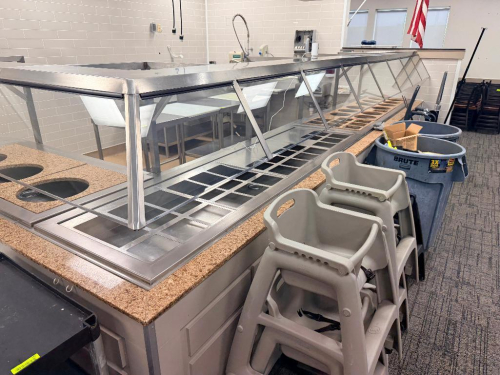 10' X 6' X 10' S-SHAPED STAINLESS STEEL SERVING LINE WITH GLASS SNEEZE GUARDS, (5) WELLS MODEL 1DD100D HEATED DROP-IN FOOD WELLS, (3) 60" SELF-CONTAINED REFRIGERATED DROP-IN WELL, A STAINLESS STEEL BASE TABLES MAY BE INCLUDED AT THE WINNING BIDDER'S OPTIO