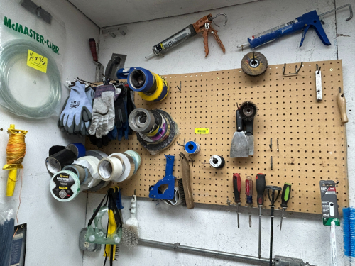 (1) LARGE ASSORTMENT OF WORK SUPPLIES AS SHOWN ON WALL