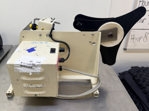 ELECTRIC LABEL APPLICATOR/DISPENSER MACHINE WITH ADJUSTABLE SENSOR ASSEMBLY, LABEL REEL HOLDERS, AND METAL FRAME