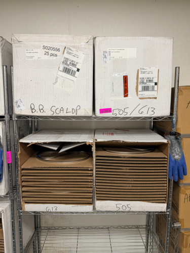 APPROX 50 WELDED STAINLESS STEEL BAND RINGS. PRECISION-FORMED METAL RINGS PACKAGED IN ORIGINAL SHIPPING CARTONS WITH SEPARATORS.