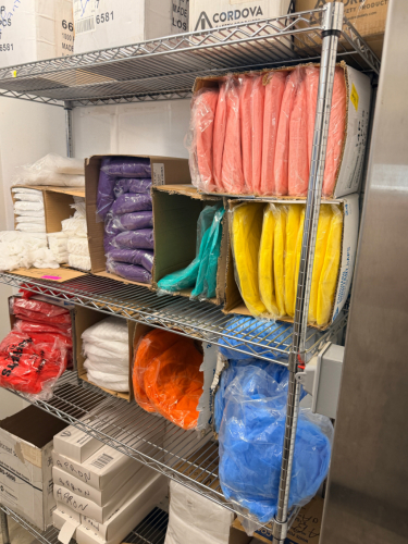 CONTENTS OF SHELF - ASSORTED OPEN CASES OF BOUFFANT CAPS.