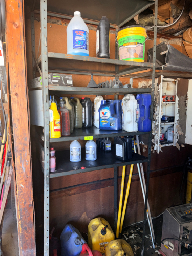 CONTENTS OF SHELF - ASSORTED OILS, LUBE, CHEMICALS, AND (5) GAS CANS