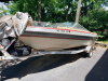 BARETTA BOWRIDER BOAT WITH WALK-THROUGH WINDSHIELD, OPEN COCKPIT SEATING, SWIM PLATFORM, REAR BOARDING LADDER, AND SINGLE STERN DRIVE. INCLUDES MATCHING ROLCO SINGLE-AXLE TRAILER. BOAT SHOWS WEATHERING, DUST ACCUMULATION, AGING INTERIOR UPHOLSTERY, AND SU - 2