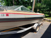 BARETTA BOWRIDER BOAT WITH WALK-THROUGH WINDSHIELD, OPEN COCKPIT SEATING, SWIM PLATFORM, REAR BOARDING LADDER, AND SINGLE STERN DRIVE. INCLUDES MATCHING ROLCO SINGLE-AXLE TRAILER. BOAT SHOWS WEATHERING, DUST ACCUMULATION, AGING INTERIOR UPHOLSTERY, AND SU - 7