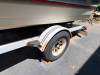 BARETTA BOWRIDER BOAT WITH WALK-THROUGH WINDSHIELD, OPEN COCKPIT SEATING, SWIM PLATFORM, REAR BOARDING LADDER, AND SINGLE STERN DRIVE. INCLUDES MATCHING ROLCO SINGLE-AXLE TRAILER. BOAT SHOWS WEATHERING, DUST ACCUMULATION, AGING INTERIOR UPHOLSTERY, AND SU - 8