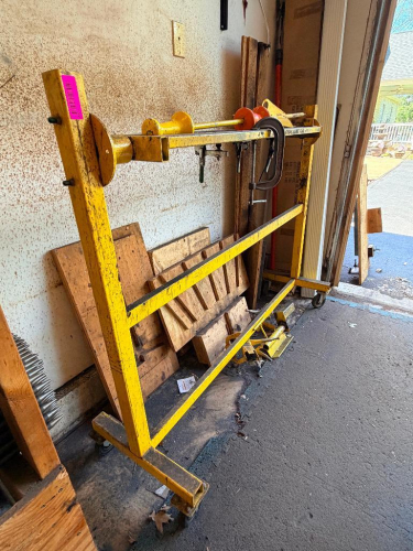 HEAVY-DUTY PORTABLE REEL STAND / SPOOL DISPENSER MOUNTED ON A WELDED STEEL FRAME WITH SWIVEL CASTERS. FEATURES ADJUSTABLE ROTATING END SUPPORTS FOR HOLDING AND DISPENSING LARGE SPOOLS OF WIRE