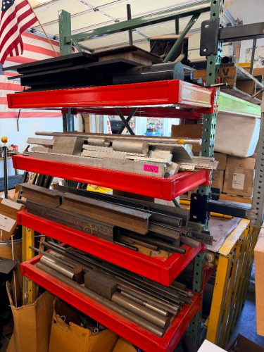 CONTENTS OF END CAP RACK - ASSORTED METAL STOCK AND ALUMINUM BAR STOCK.