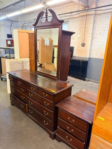 TRADITIONAL BEDROOM FURNITURE SET CONSISTING OF A NINE-DRAWER DRESSER WITH ATTACHED FRAMED MIRROR AND MATCHING THREE-DRAWER NIGHTSTAND.