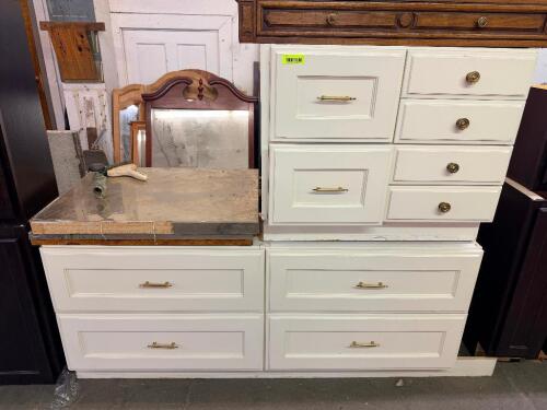 WHITE PAINTED CABINETRY SET CONSISTING OF MULTIPLE BASE CABINET SECTIONS WITH RAISED PANEL FRONTS, BRASS-TONE HARDWARE, AND INTEGRATED STORAGE DRAWERS