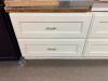 WHITE PAINTED CABINETRY SET CONSISTING OF MULTIPLE BASE CABINET SECTIONS WITH RAISED PANEL FRONTS, BRASS-TONE HARDWARE, AND INTEGRATED STORAGE DRAWERS - 2