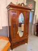 ANTIQUE STYLE ARMOIRE/WARDROBE FEATURING A CARVED CROWN PEDIMENT, CENTRAL OVAL MIRRORED DOOR, DECORATIVE WOOD PANELS, AND A FULL-WIDTH LOWER STORAGE DRAWER. CONSTRUCTED OF WOOD WITH FIGURED VENEER ACCENTS AND TRADITIONAL HARDWARE.