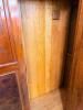 ANTIQUE STYLE ARMOIRE/WARDROBE FEATURING A CARVED CROWN PEDIMENT, CENTRAL OVAL MIRRORED DOOR, DECORATIVE WOOD PANELS, AND A FULL-WIDTH LOWER STORAGE DRAWER. CONSTRUCTED OF WOOD WITH FIGURED VENEER ACCENTS AND TRADITIONAL HARDWARE. - 3