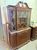 TRADITIONAL CHINA CABINET/HUTCH FEATURING A TWO-PIECE DESIGN WITH GLAZED DISPLAY DOORS, DECORATIVE MUNTIN PATTERN GLASS PANELS, LOWER STORAGE CABINET, AND SINGLE CENTER DRAWER. CONSTRUCTED OF WOOD WITH A DARK FINISH AND DECORATIVE CROWN PEDIMENT. - 2