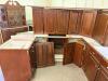 DARK CHERRY FINISH KITCHEN CABINET SET CONSISTING OF MULTIPLE WALL CABINETS, BASE CABINETS, CORNER CABINET SECTIONS, DRAWER BASES, AND APPLIANCE SURROUND CABINETRY. FEATURES RAISED PANEL DOORS AND MATCHING FINISH THROUGHOUT.