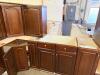 DARK CHERRY FINISH KITCHEN CABINET SET CONSISTING OF MULTIPLE WALL CABINETS, BASE CABINETS, CORNER CABINET SECTIONS, DRAWER BASES, AND APPLIANCE SURROUND CABINETRY. FEATURES RAISED PANEL DOORS AND MATCHING FINISH THROUGHOUT. - 3