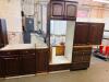 DARK CHERRY FINISH KITCHEN CABINET SET CONSISTING OF MULTIPLE WALL CABINETS, BASE CABINETS, CORNER CABINET SECTIONS, DRAWER BASES, AND APPLIANCE SURROUND CABINETRY. FEATURES RAISED PANEL DOORS AND MATCHING FINISH THROUGHOUT. - 4