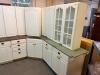 WHITE PAINTED KITCHEN CABINET SET CONSISTING OF MULTIPLE WALL CABINETS, BASE CABINETS, CORNER CABINET SECTIONS, GLASS-FRONT DISPLAY CABINETS, DRAWER BASES, AND WOOD COUNTERTOP SECTIONS. FEATURES RAISED PANEL DOORS AND DECORATIVE HARDWARE THROUGHOUT. - 2