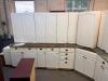 WHITE PAINTED KITCHEN CABINET SET CONSISTING OF MULTIPLE WALL CABINETS, BASE CABINETS, CORNER CABINET SECTIONS, GLASS-FRONT DISPLAY CABINETS, DRAWER BASES, AND WOOD COUNTERTOP SECTIONS. FEATURES RAISED PANEL DOORS AND DECORATIVE HARDWARE THROUGHOUT. - 3