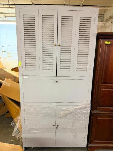 WHITE PAINTED WOOD STORAGE CABINET WITH LOUVERED UPPER DOORS, A DROP-FRONT WORK SURFACE, AND LOWER DOUBLE-DOOR STORAGE CABINET