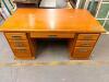 72" WOOD DOUBLE PEDESTAL EXECUTIVE DESK WITH A NATURAL WOOD FINISH, RECTANGULAR WORK SURFACE, SEVEN TOTAL DRAWERS, AND DECORATIVE METAL PULL HANDLES.