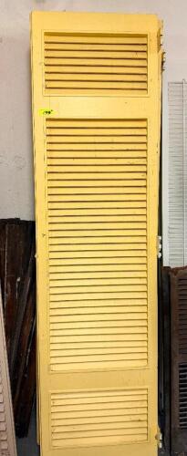 (2) 24" WOOD LOUVERED INTERIOR DOOR WITH THREE LOUVERED PANELS AND PAINTED YELLOW FINISH.