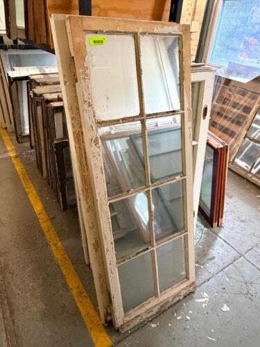 24 IN. W X 53 IN. VINTAGE WOOD WINDOW SASH WITH 8-LITE TRUE DIVIDED GLASS. PAINTED WHITE FINISH.
